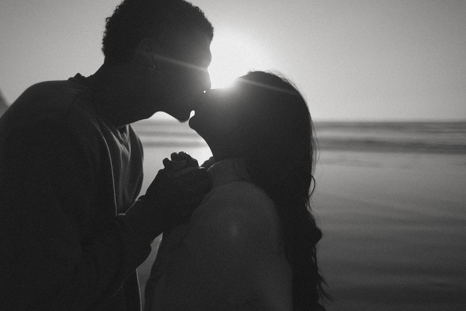 Couple shares a kiss on Cannon Beach on the Oregon Coast.