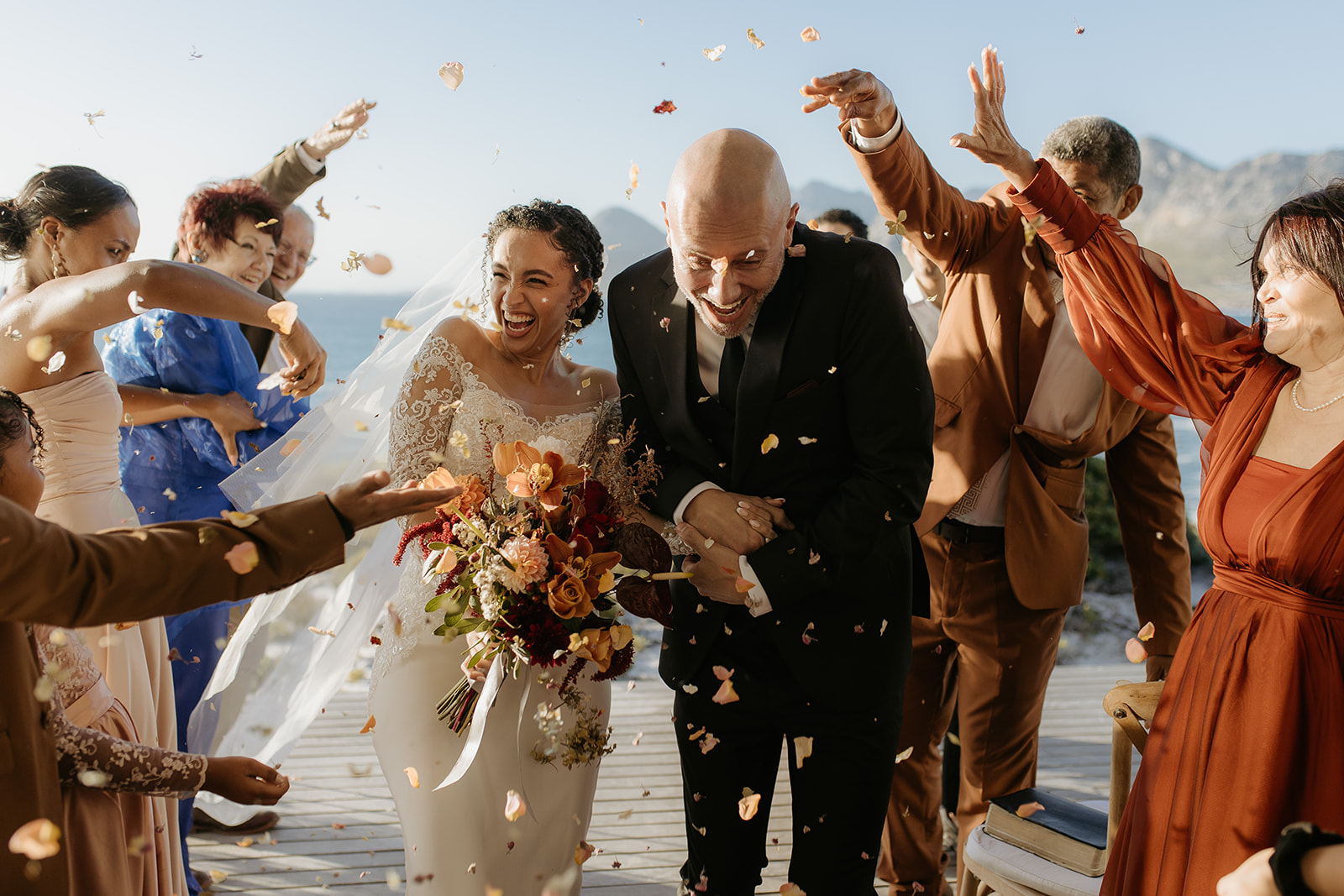 A bride and groom going through confetti at their intimate wedding in Pringle Bay, Western Cape