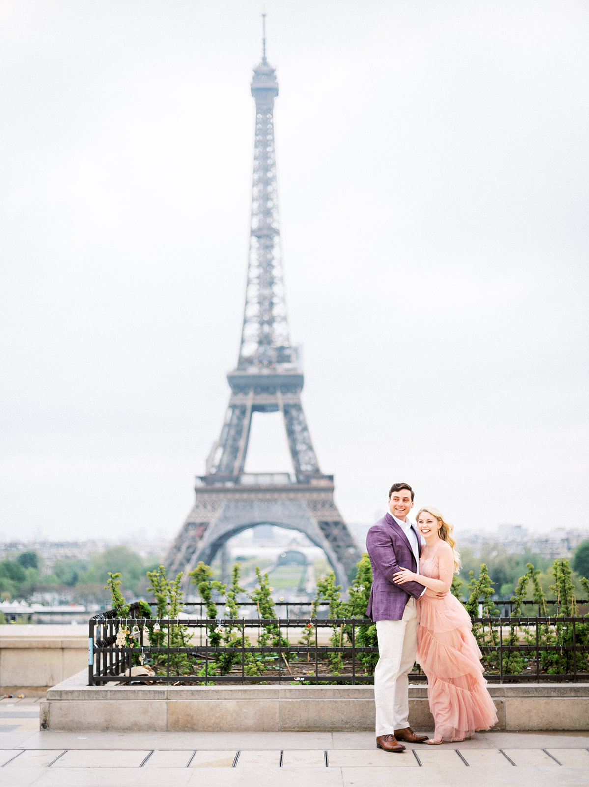 Couple happy with Eiffel Tower in the background.