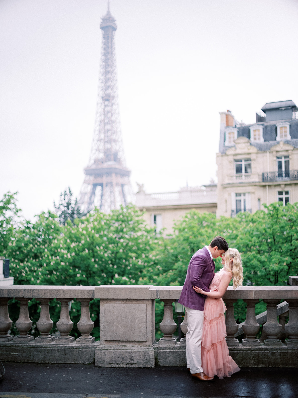 Couple kissing near the Eiffel Tower.