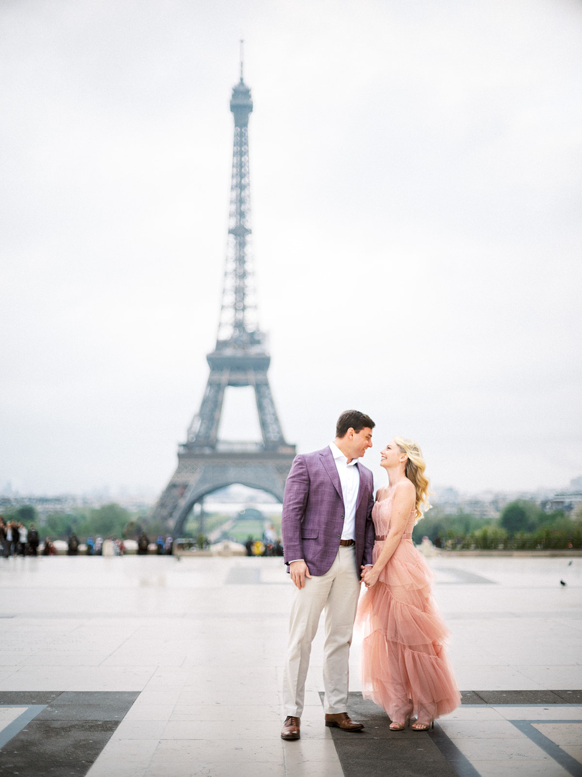 Couple looking at each other with Eiffel Tower in the background.