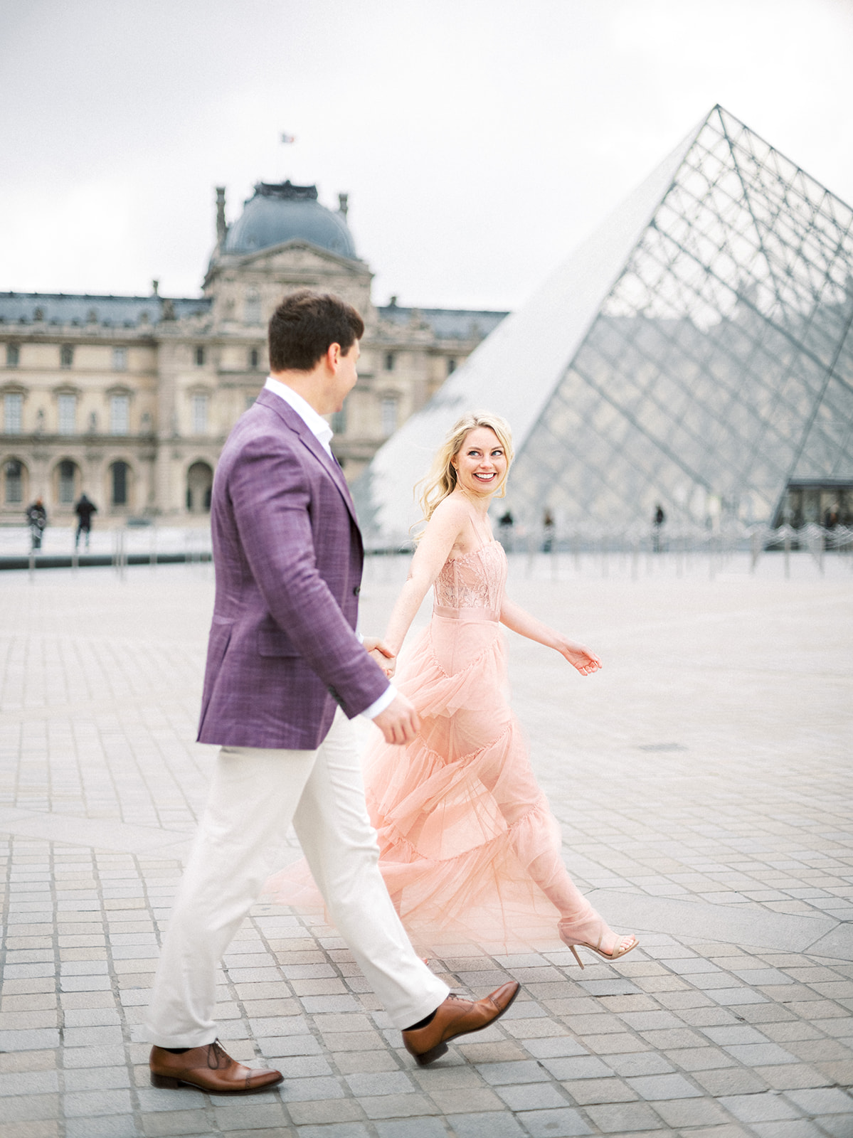 Couple walking away during their Paris engagement session.