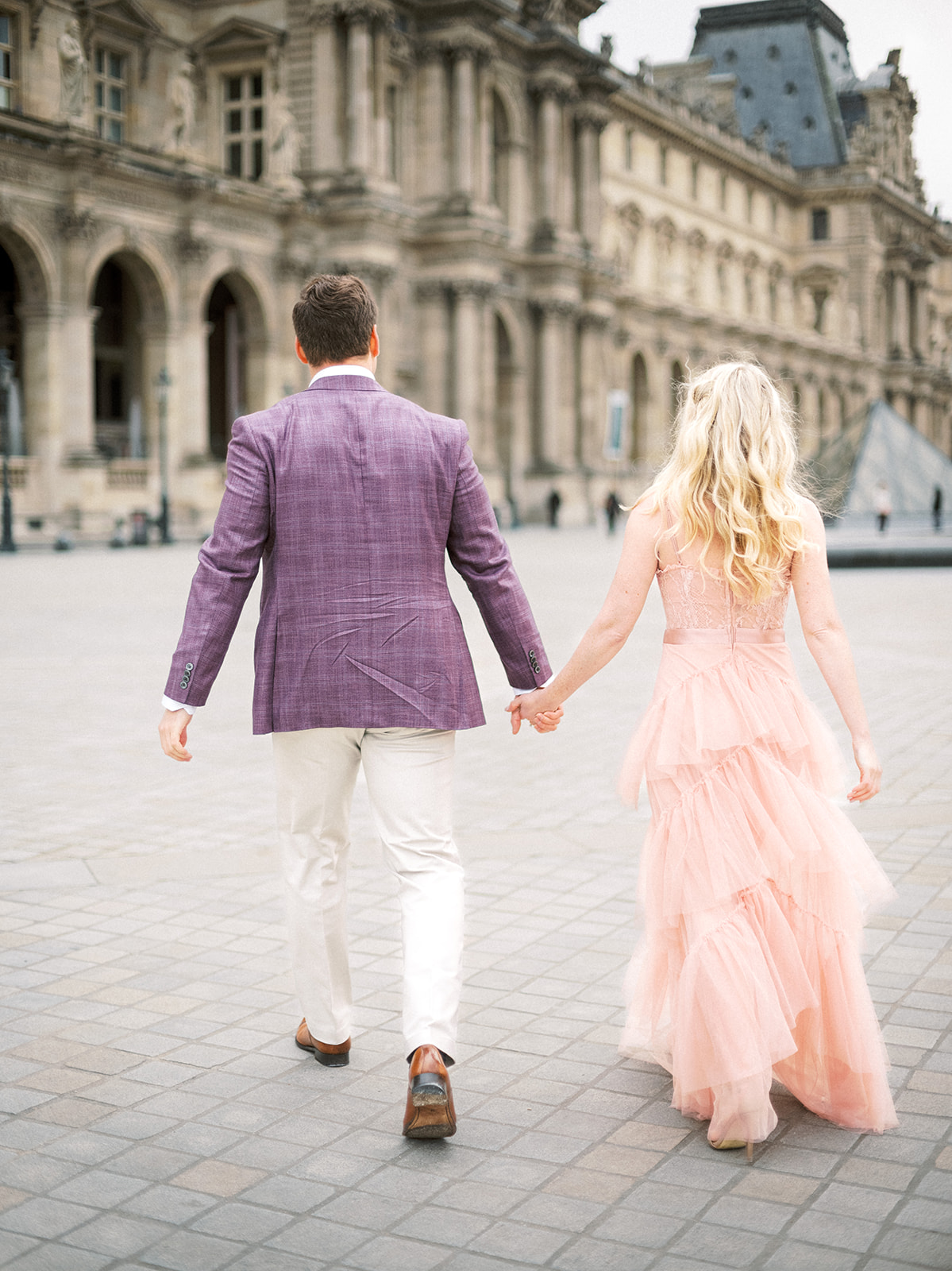 Couple walking near Louvre.