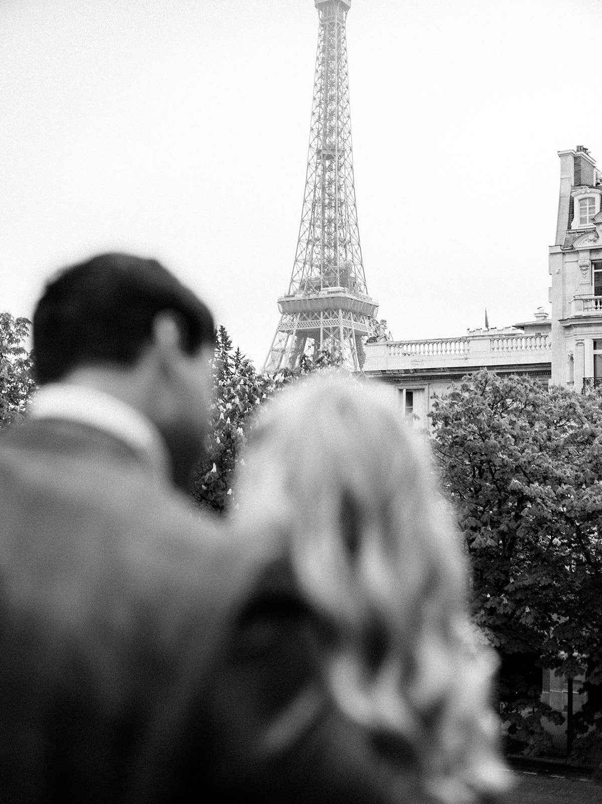 Silhouette of couple with Eiffel Tower in background.