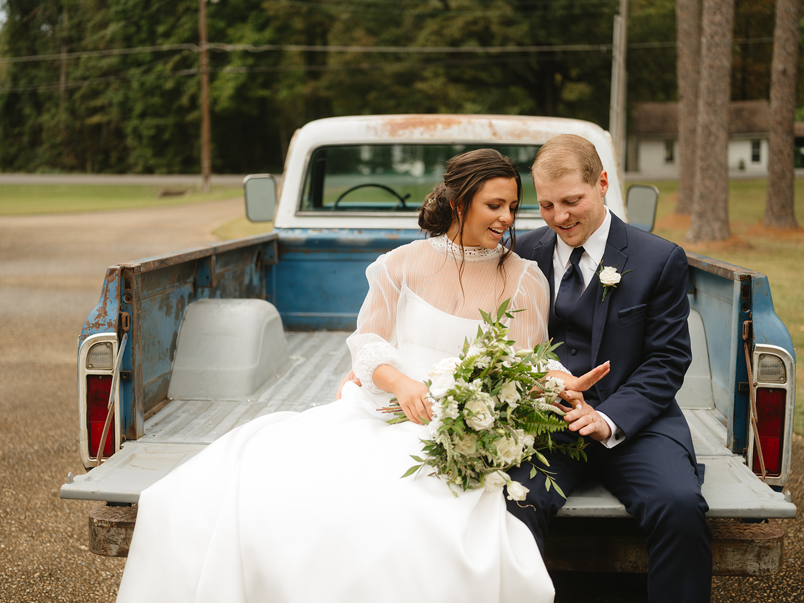 farm truck with bride and groom
