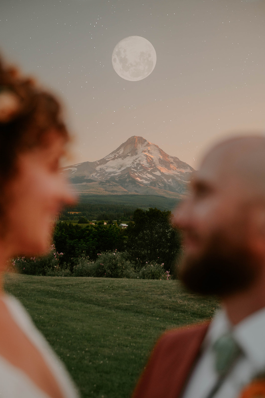 bride and groom with mountain and full moon
