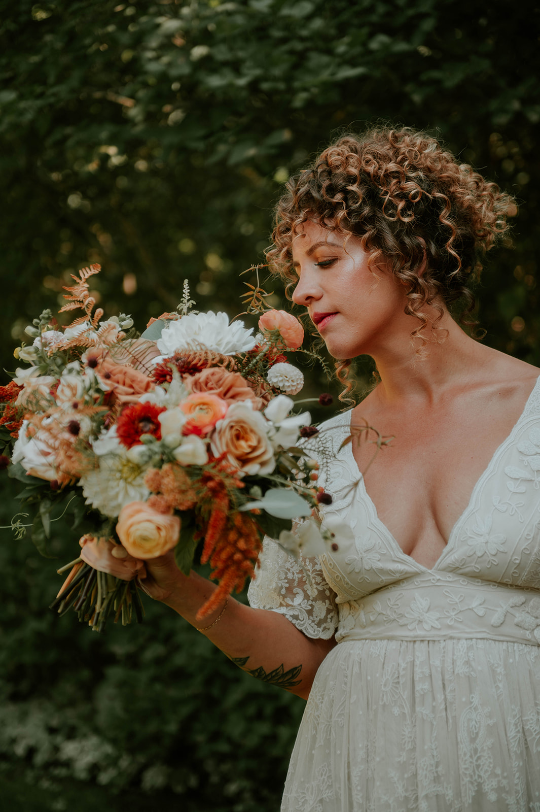 bride smelling her bouquet in bhldn dress