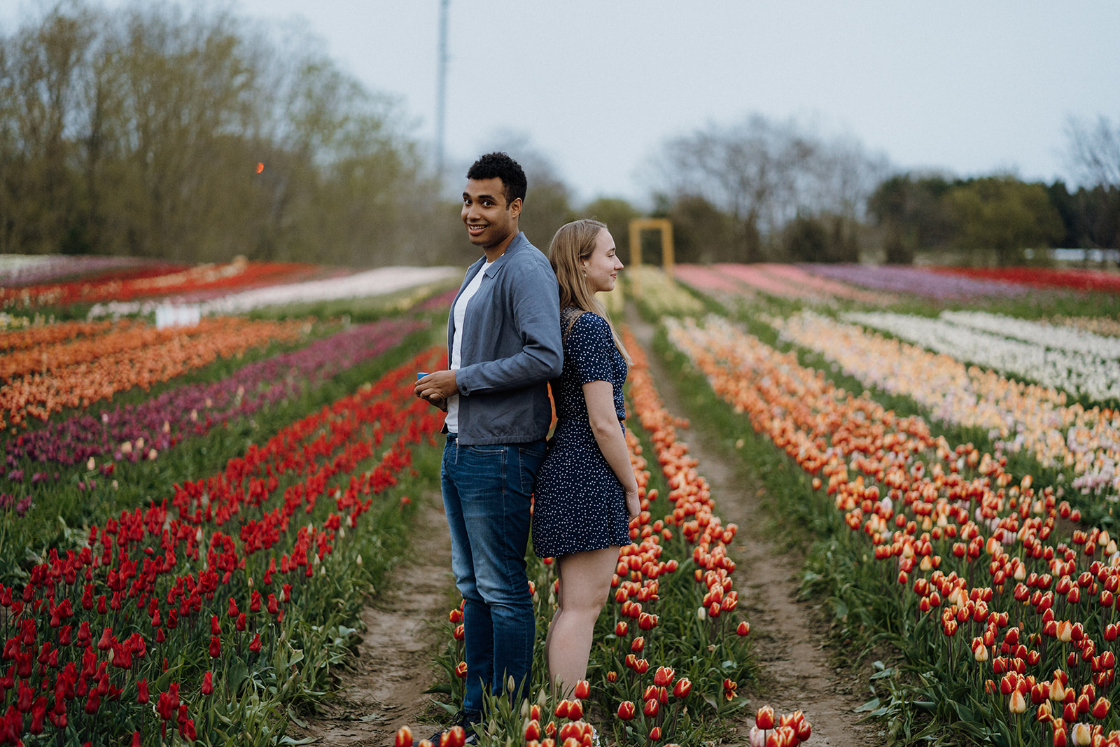 Man and woman standing back to back in Tulips.