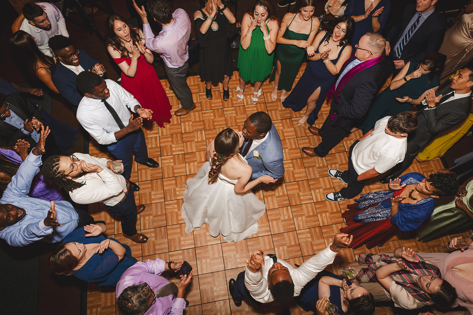 an overhead view of a bride and groom dancing  surrounded by their wedding guests