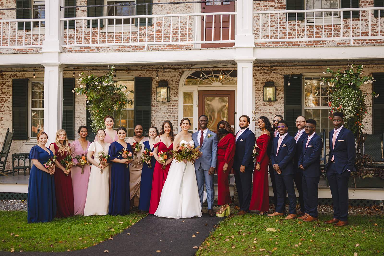 a wedding party poses in front of an historic New England Inn in  Grafton Vermont