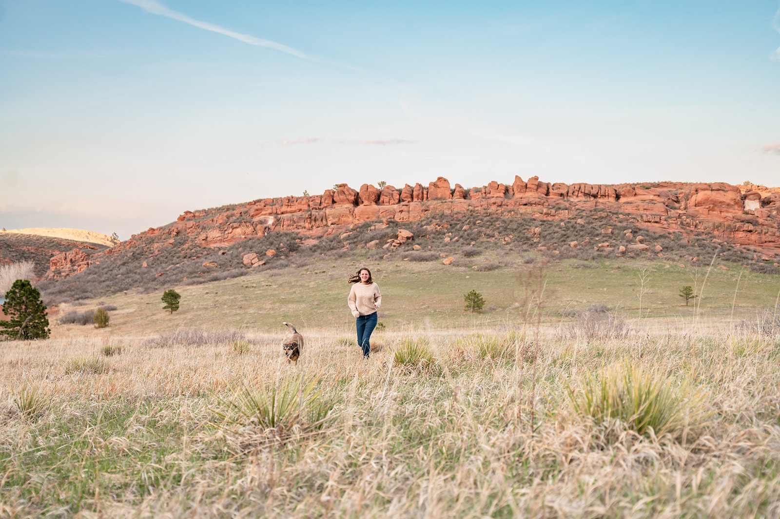 Fort Collins, CO girl hikes with her dog around Lory State Park.