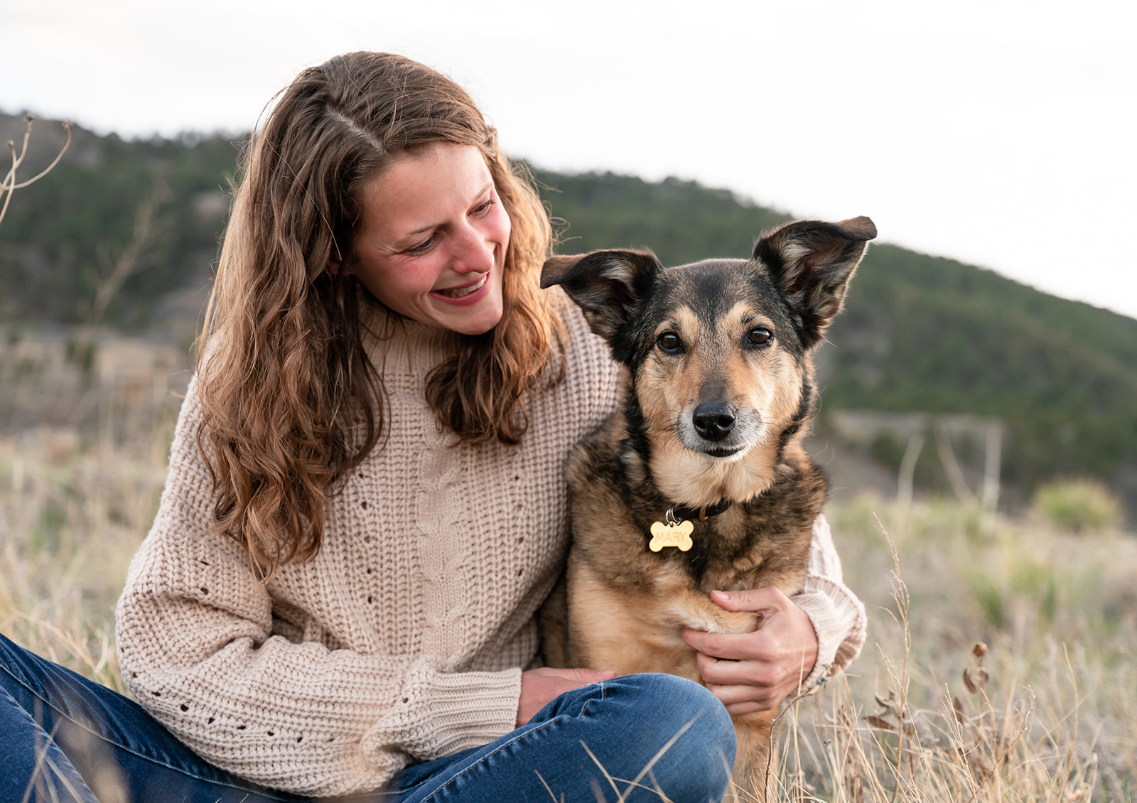 Woman and her dog enjoy a sweet moment while visiting Lory State Park near Fort Collins, Colorado