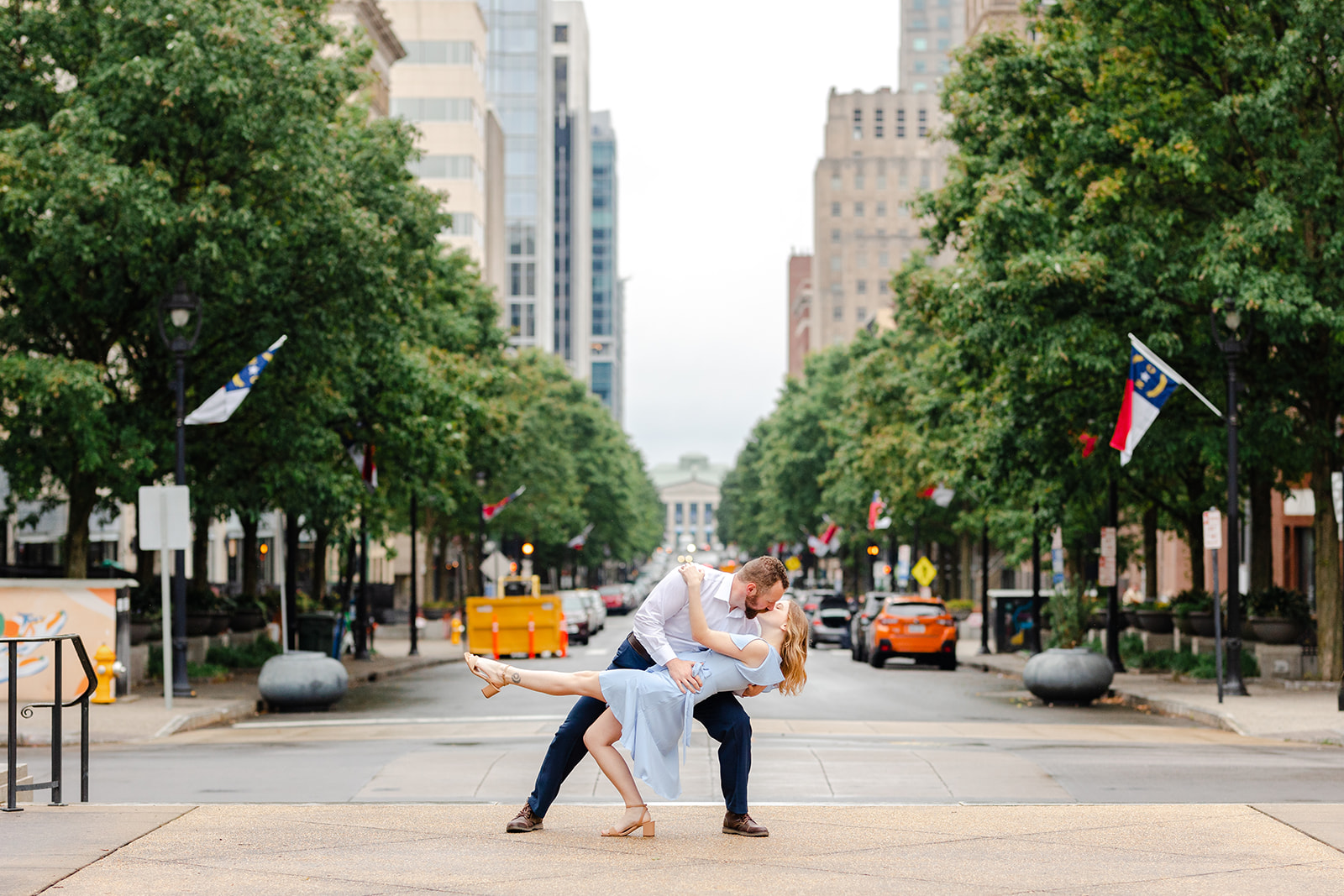 Couple dipping in front of Fayetteville Street in Downtown Raleigh