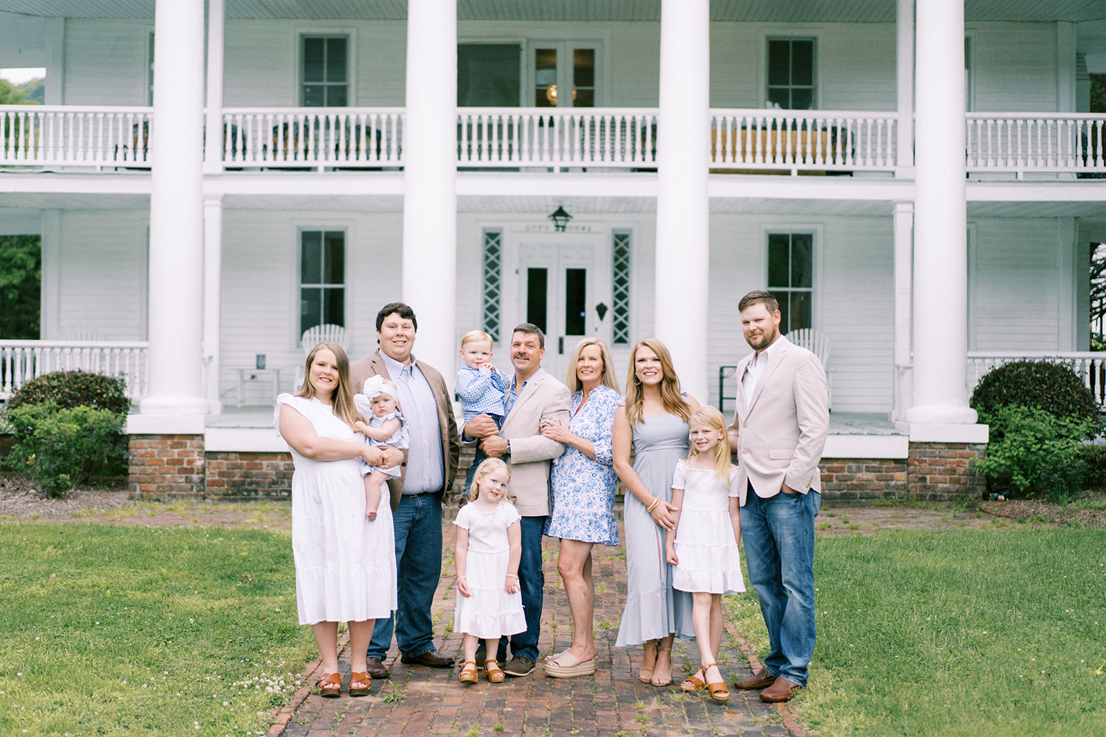 A large family poses in front of the Winston Place in Valley Head, Alabama for a photograph