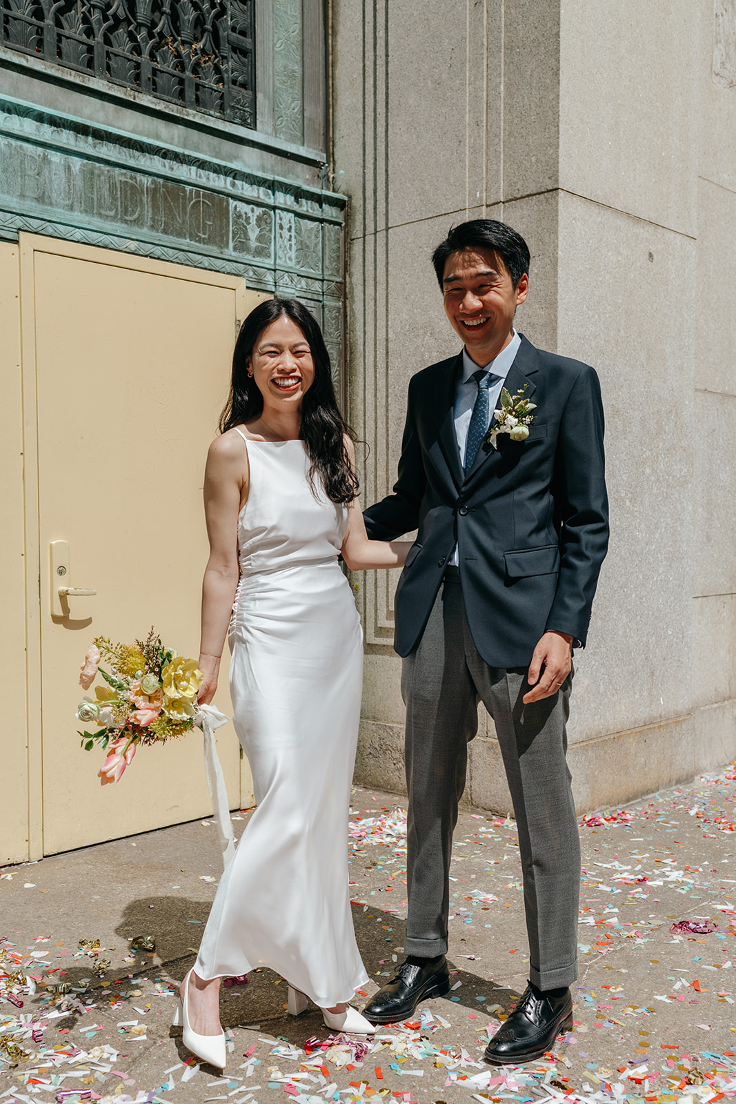 bride and groom outside after nyc city hall elopement