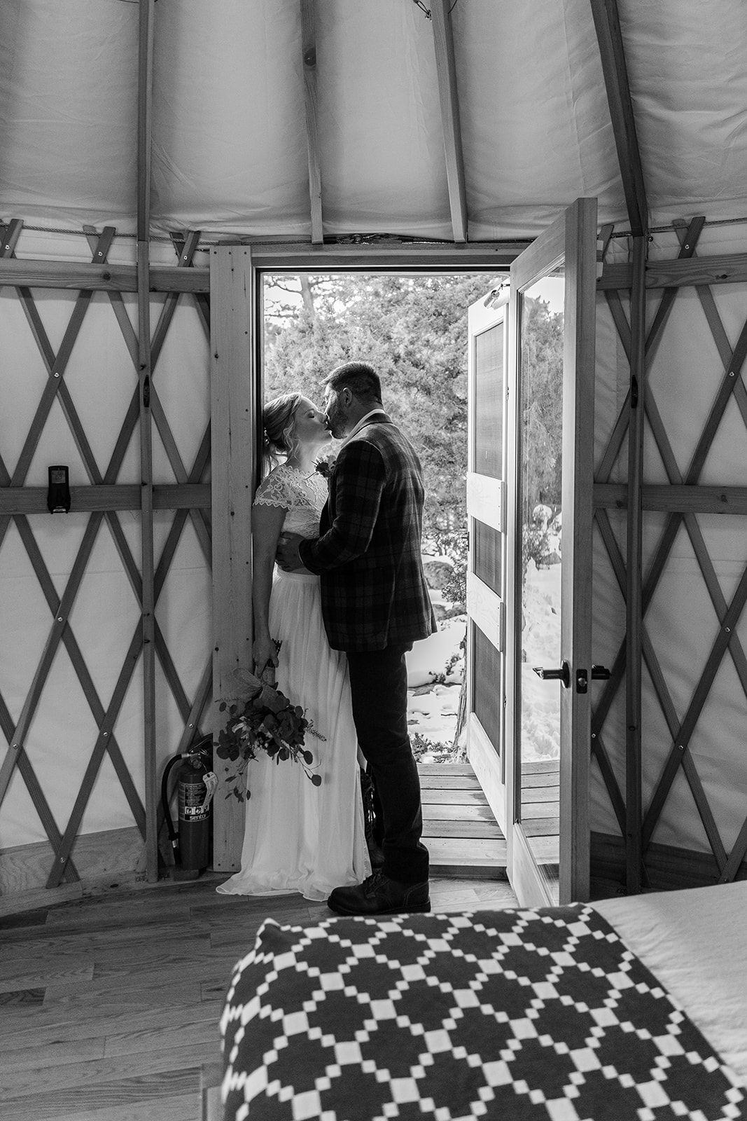 Eloping couple embracing before their ceremony in their yurt in Hope Valley, CA 