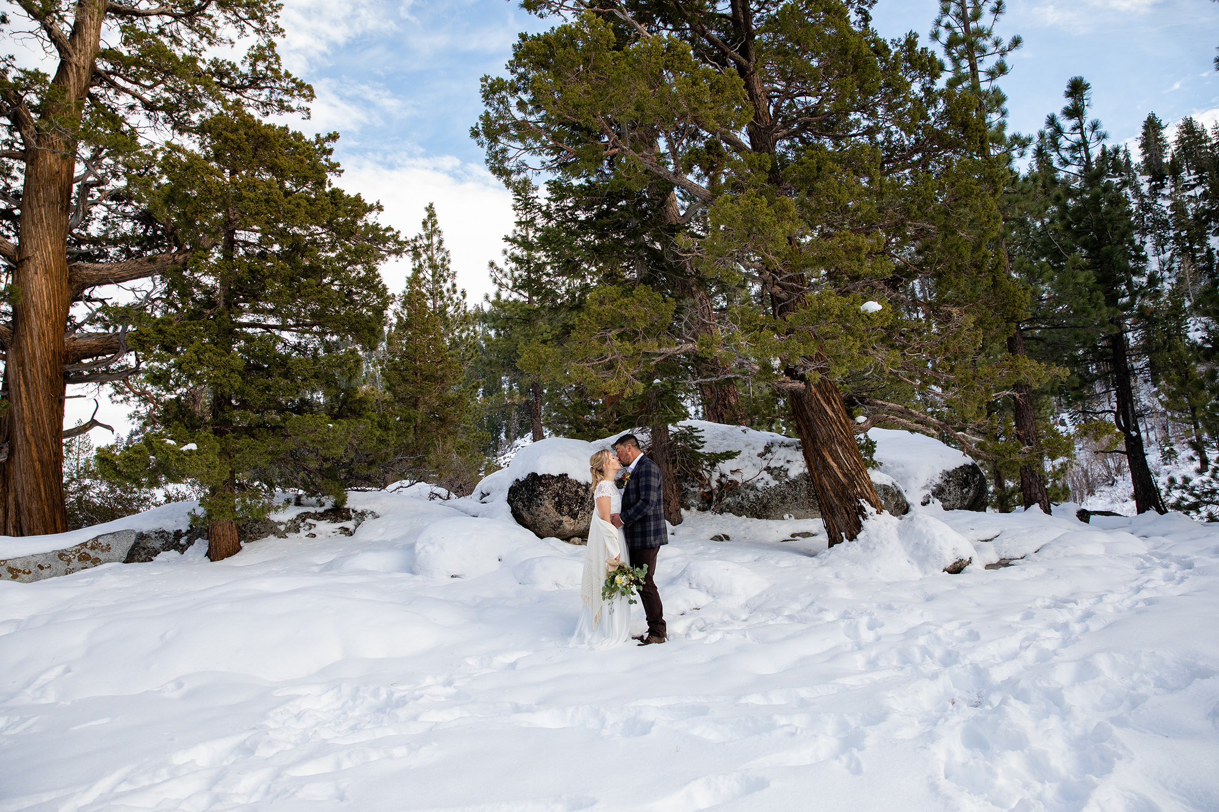 Eloping couple kissing in the mountains of Lake Tahoe. 