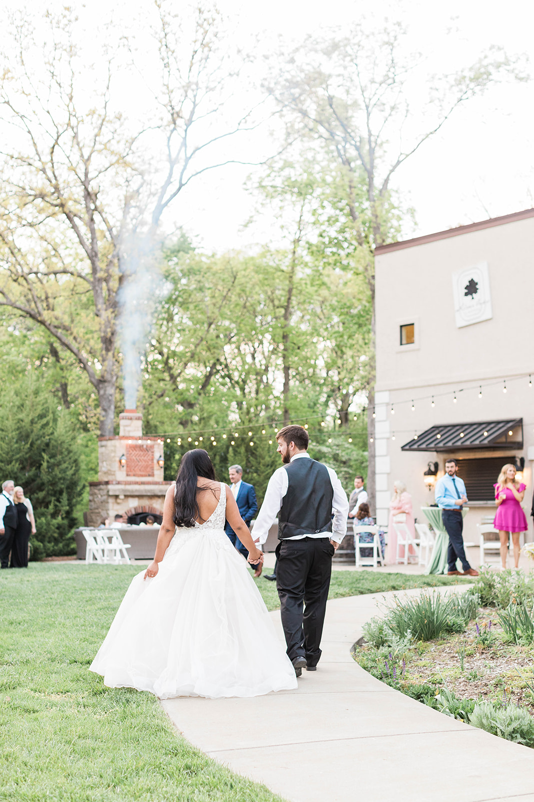 A Missouri wedding with a couple entering cocktail hour on the patio at Silver Oaks Chateau