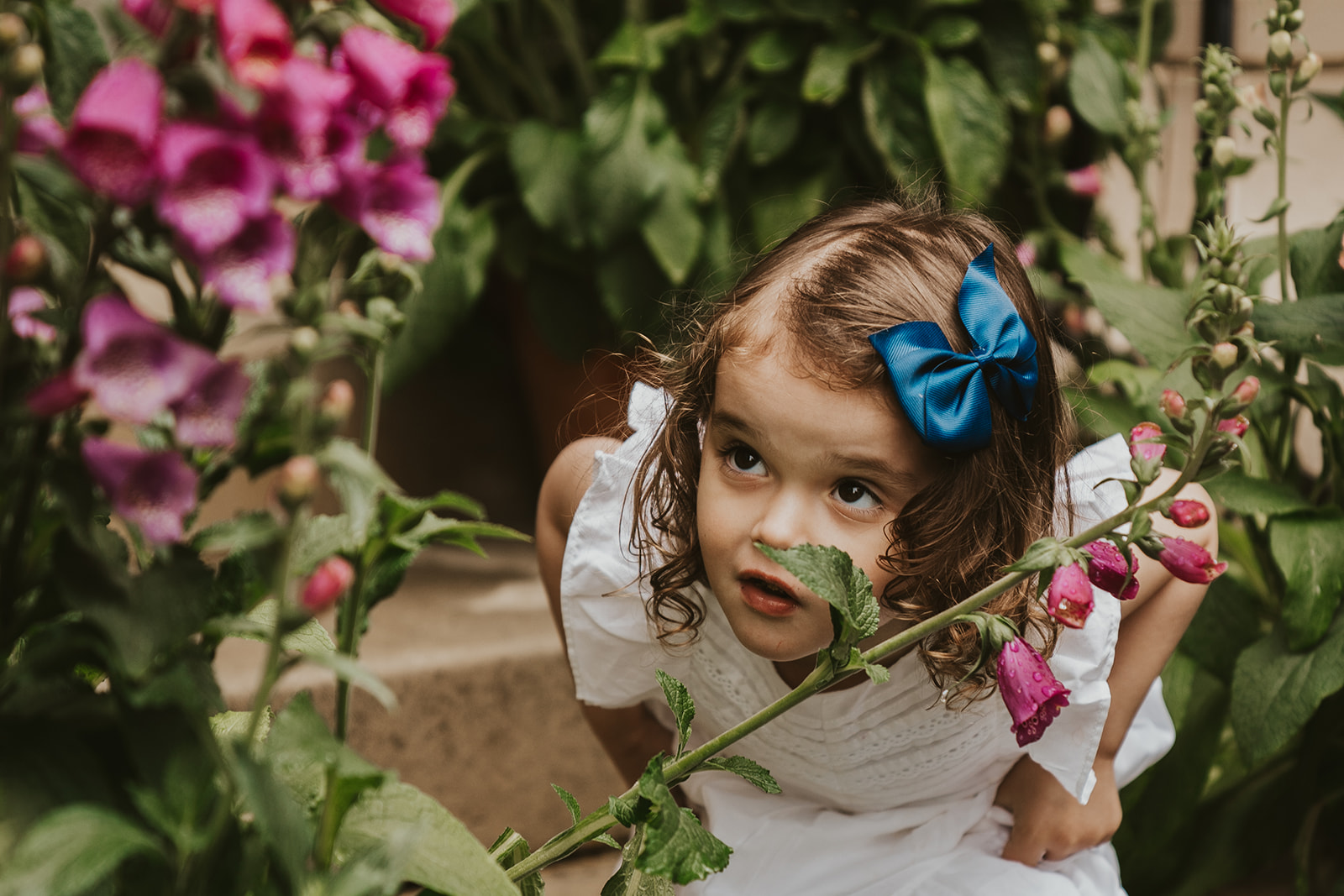 Young girl looking at flowers
