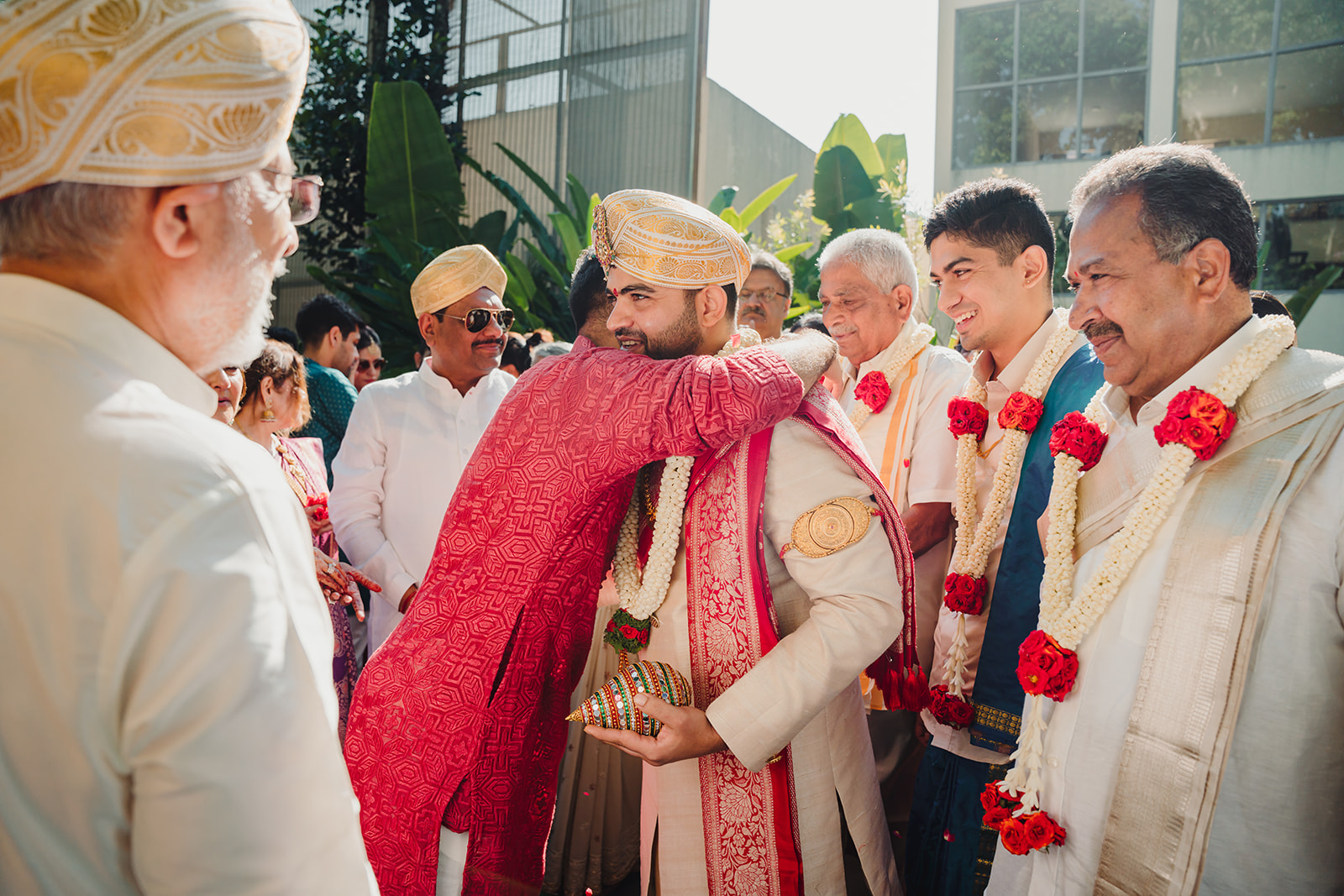 Celebratory embrace: A heartwarming moment as guests greet the groom with smiles and enthusiasm
