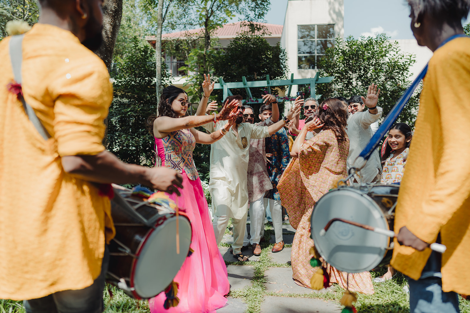 Energetic celebration: Bride joyfully dancing to the lively rhythm of the dhol