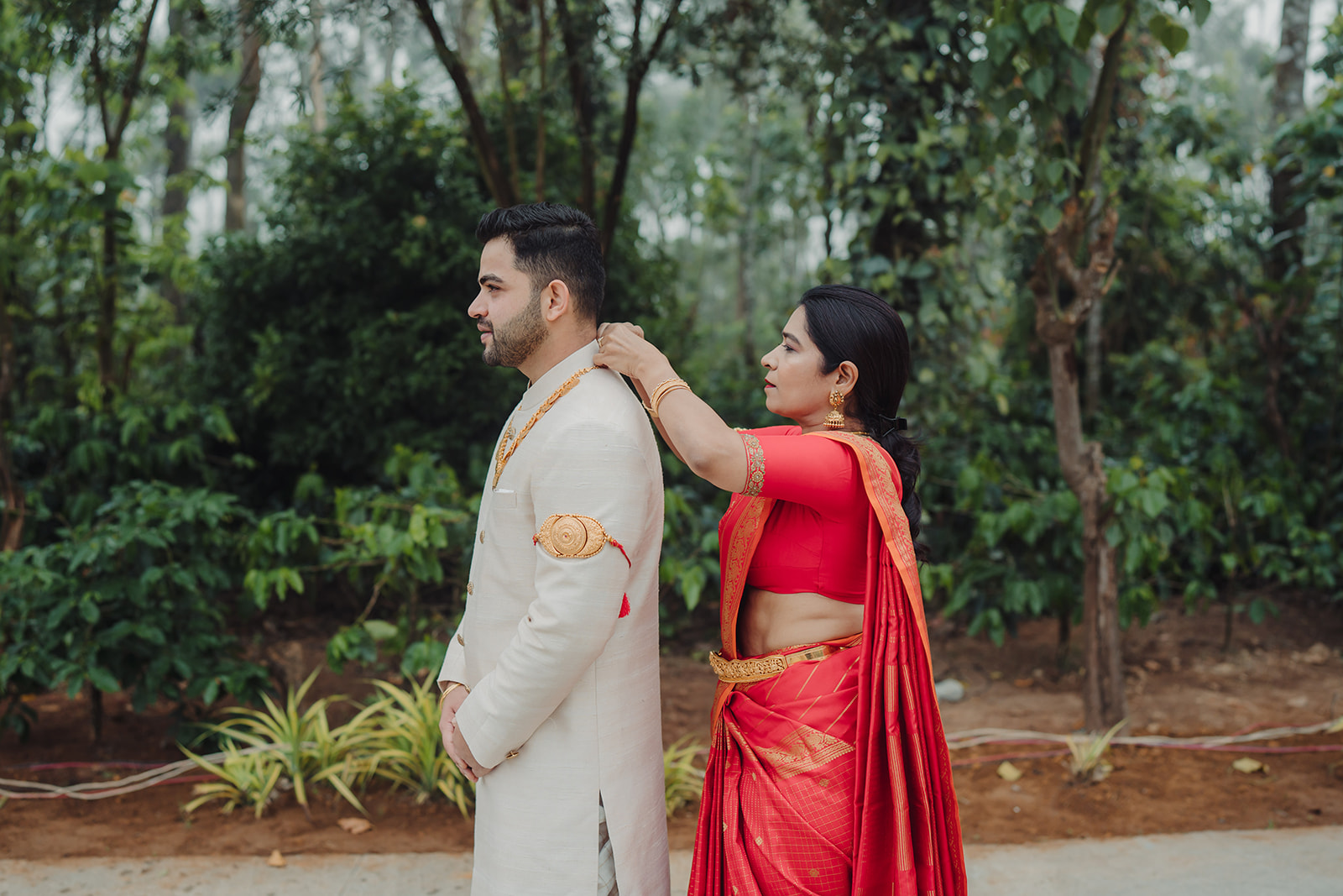 Cultural charm: Groom wears traditional jewelry, adding flair to his attire