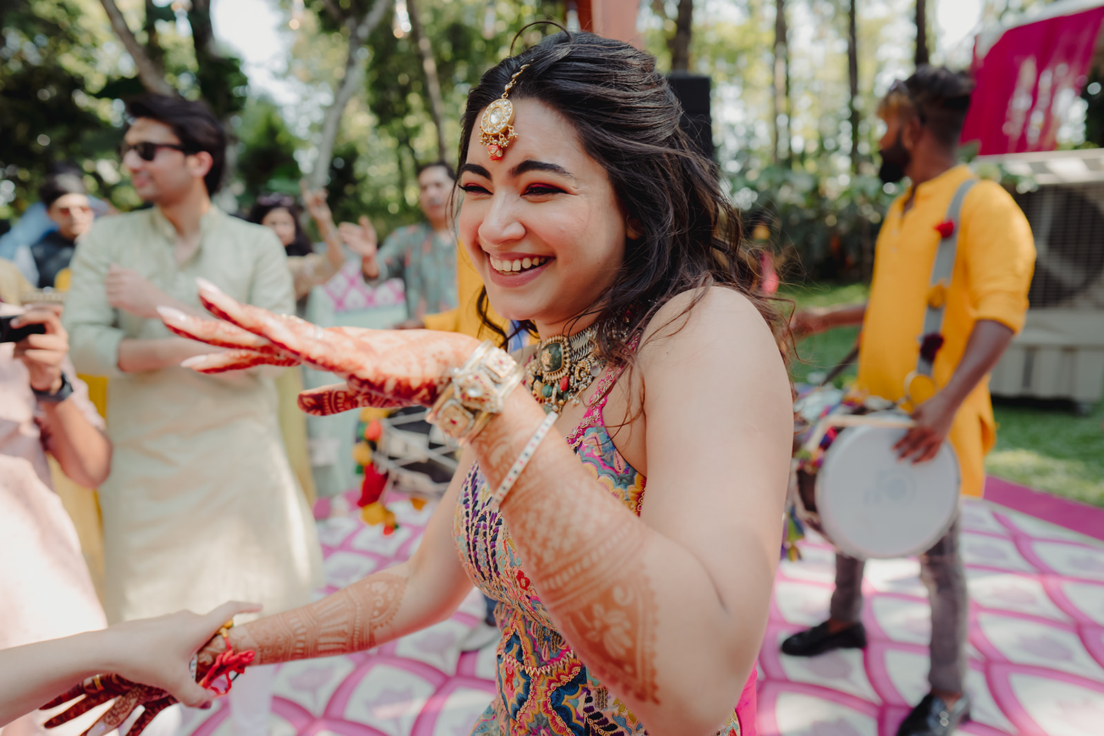 Bridal rhythm: Bride joyfully dancing to the lively and traditional dhol music.