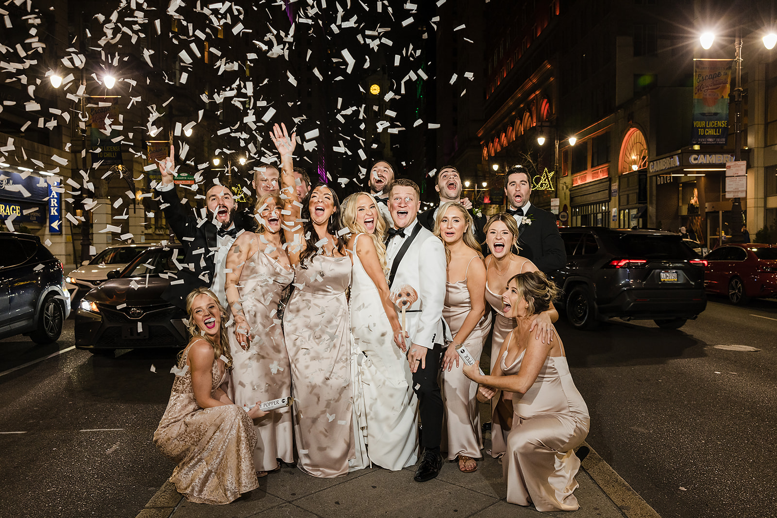 Confetti shot bridal party wedding photo on the Broad Street in Philadelphia 