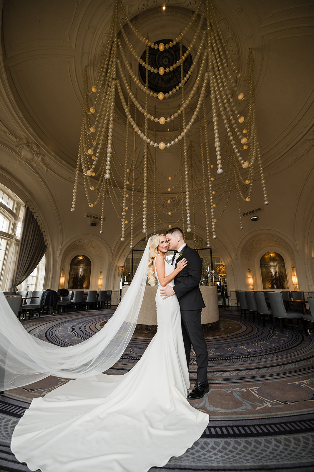 Wedding portraits at the XIX Restaurant with pearl chandelier at Bellevue Hotel Philadelphia
