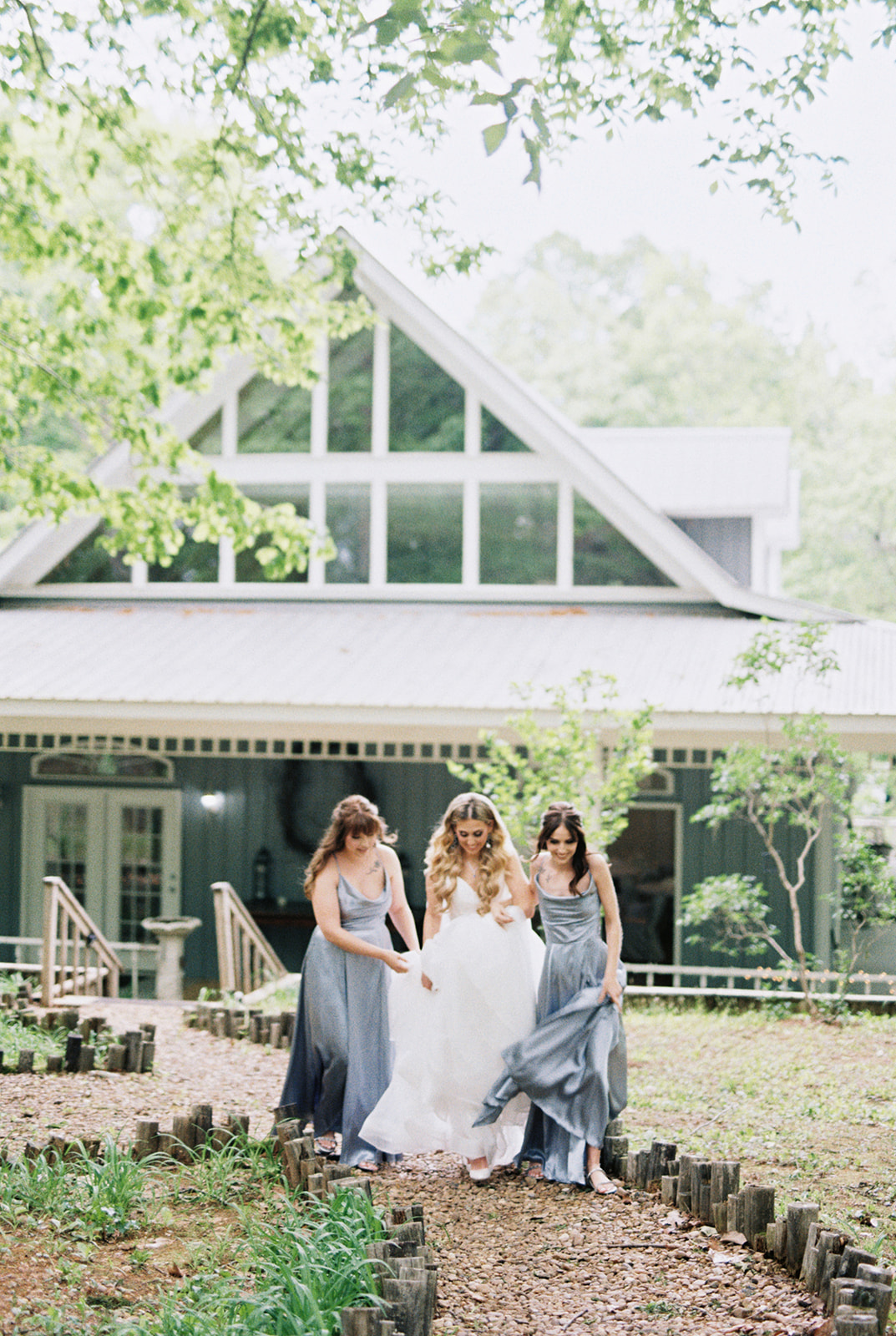 The bridesmaids help the bride get to the ceremony in the chapel at Fernwood of Mentone