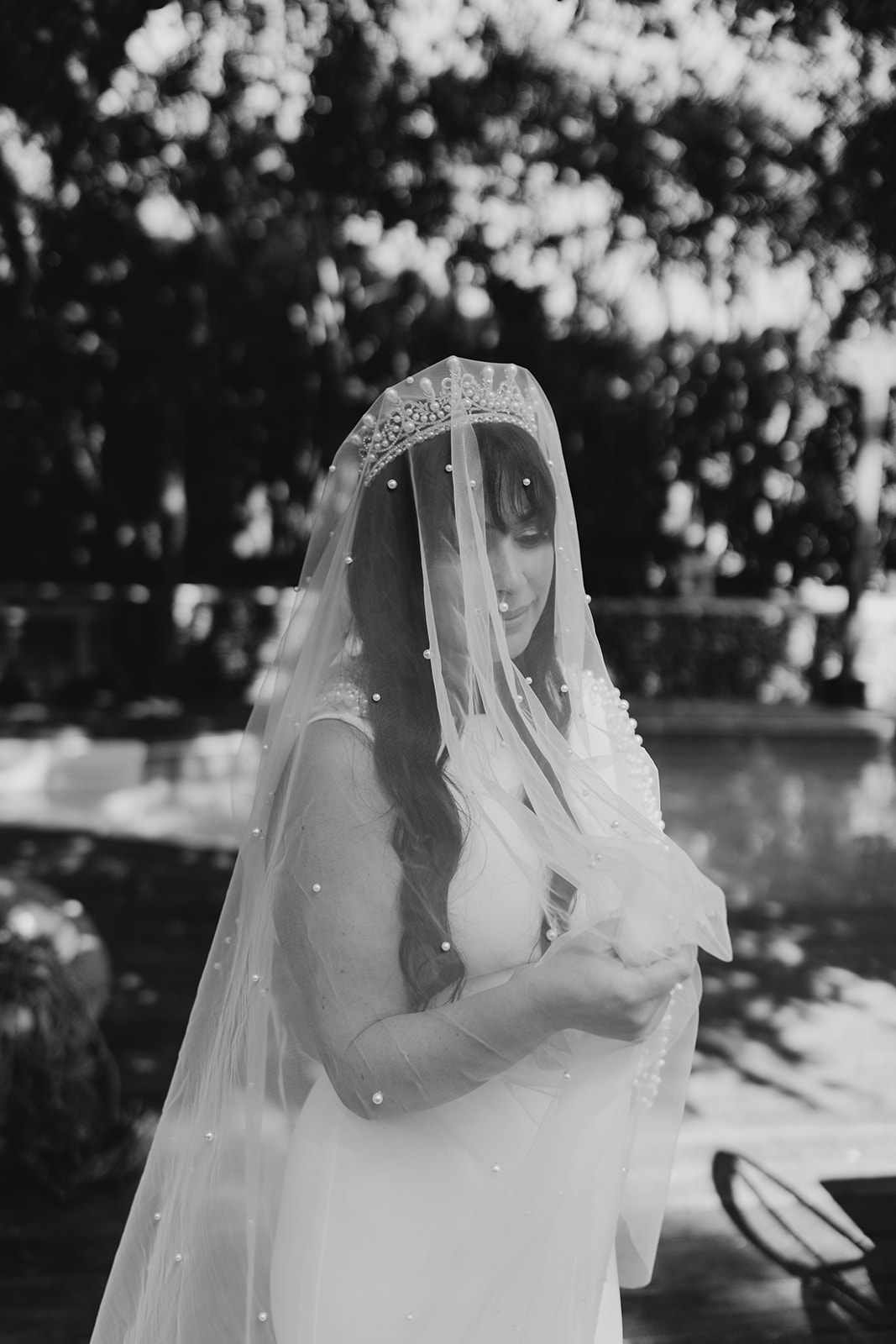black and white photo of bride wearing a crown and beaded veil