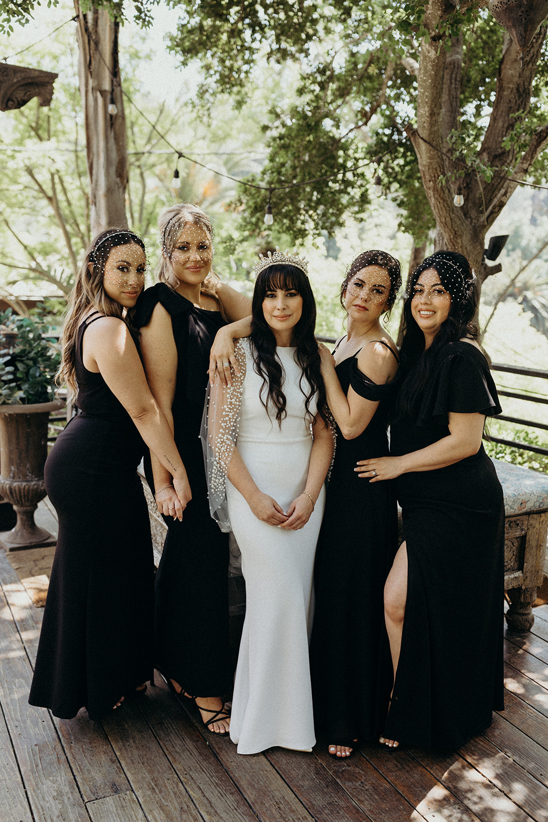 bride with bridesmaids wearing black