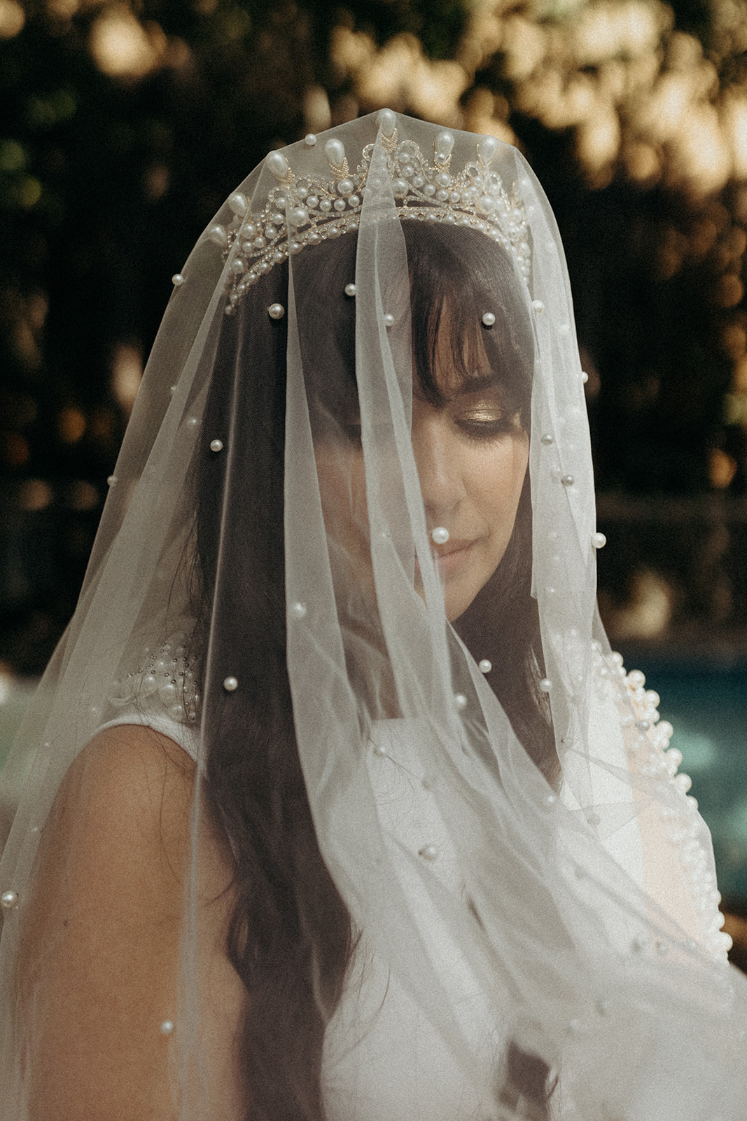 bride style wearing a crown and beaded veil