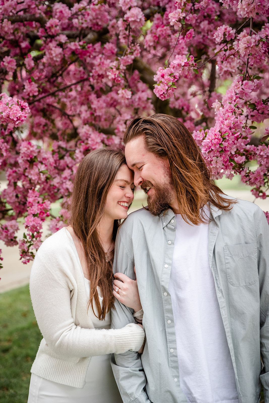 Couple touching foreheads during engagement shoot