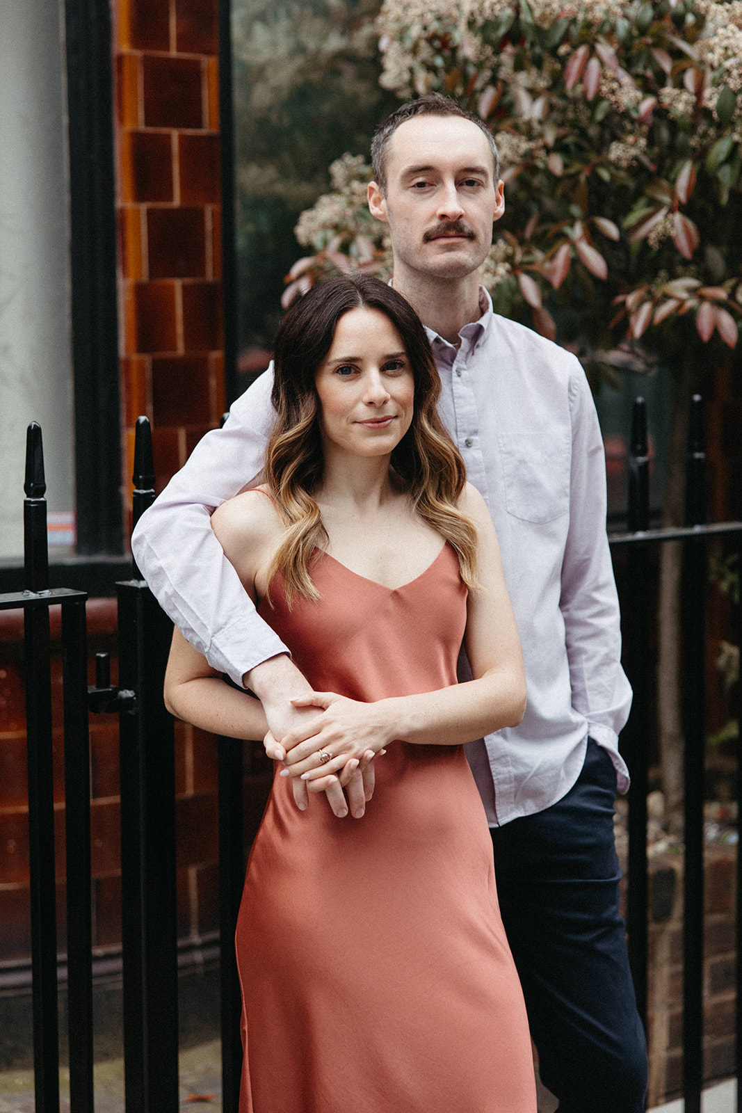 A newly engaged couple poses for a portrait in London during their city engagement session in England. 