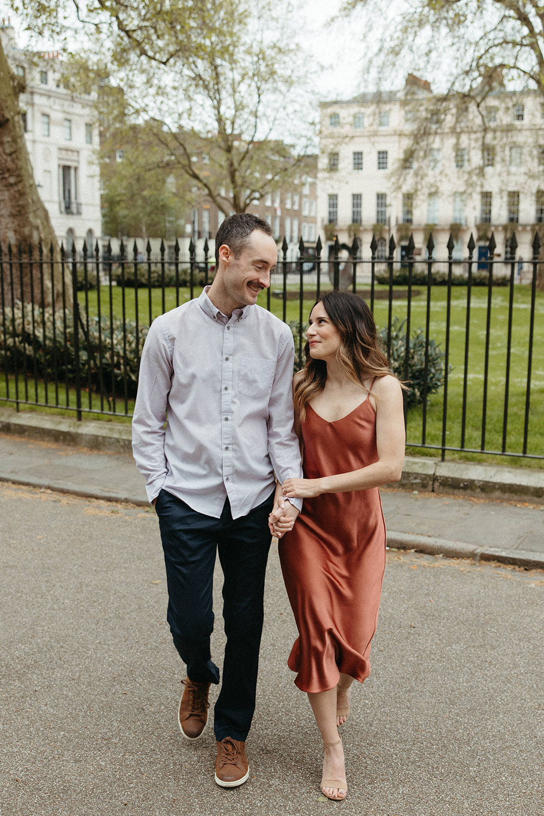An engaged couple walks through the streets of London during their luxury engagement session. 