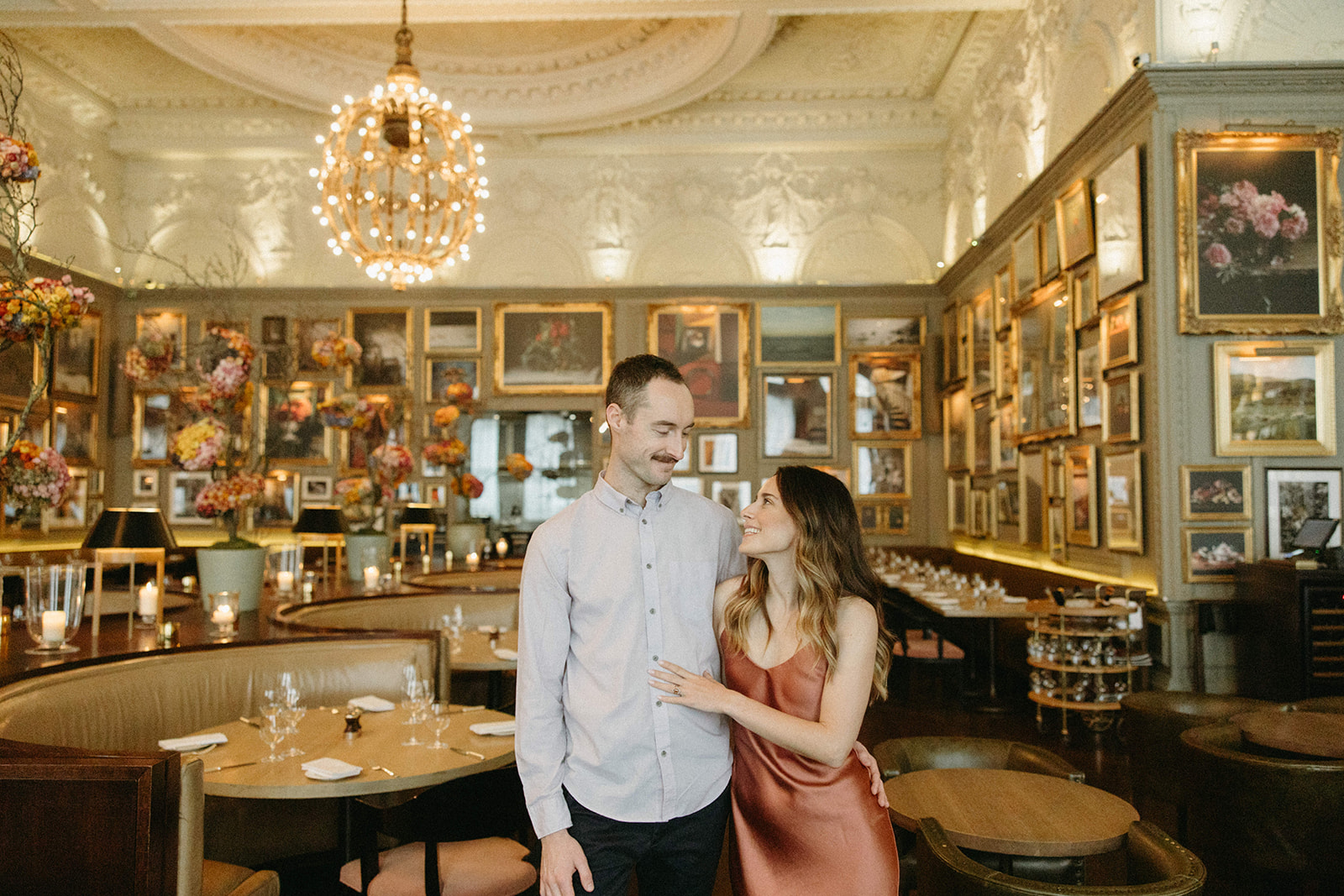 An engaged couple embracing in Berner’s Tavern during their romantic restaurant engagement session. 