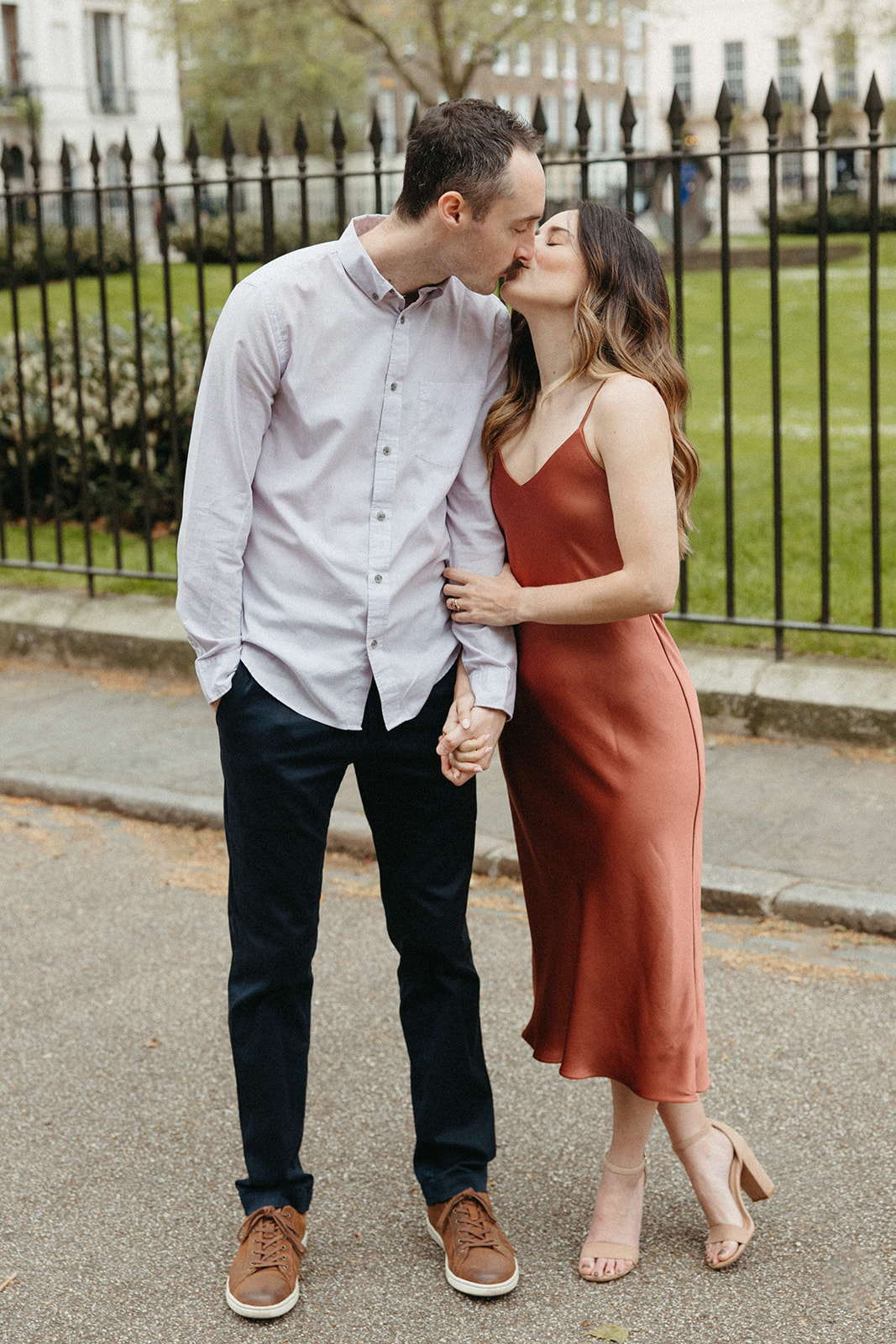A newly engaged couple kisses in the streets of London during their luxury city engagement session. 