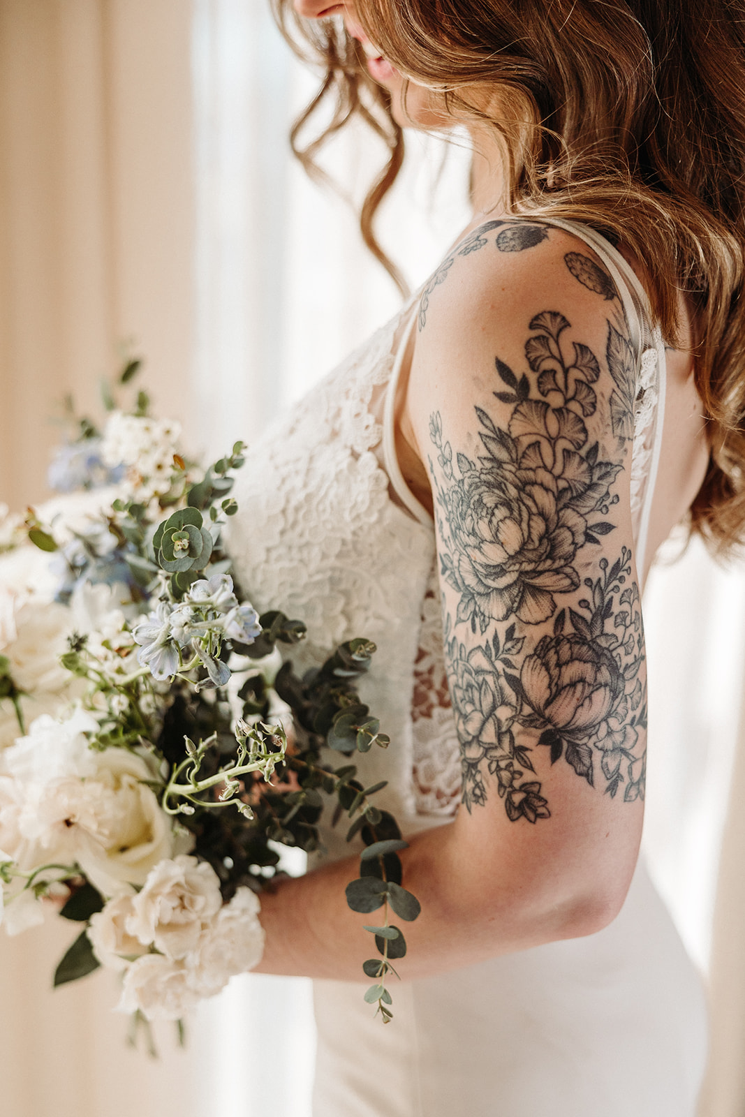 Bride portrait with her lace bodice wedding dress and wedding bouquet