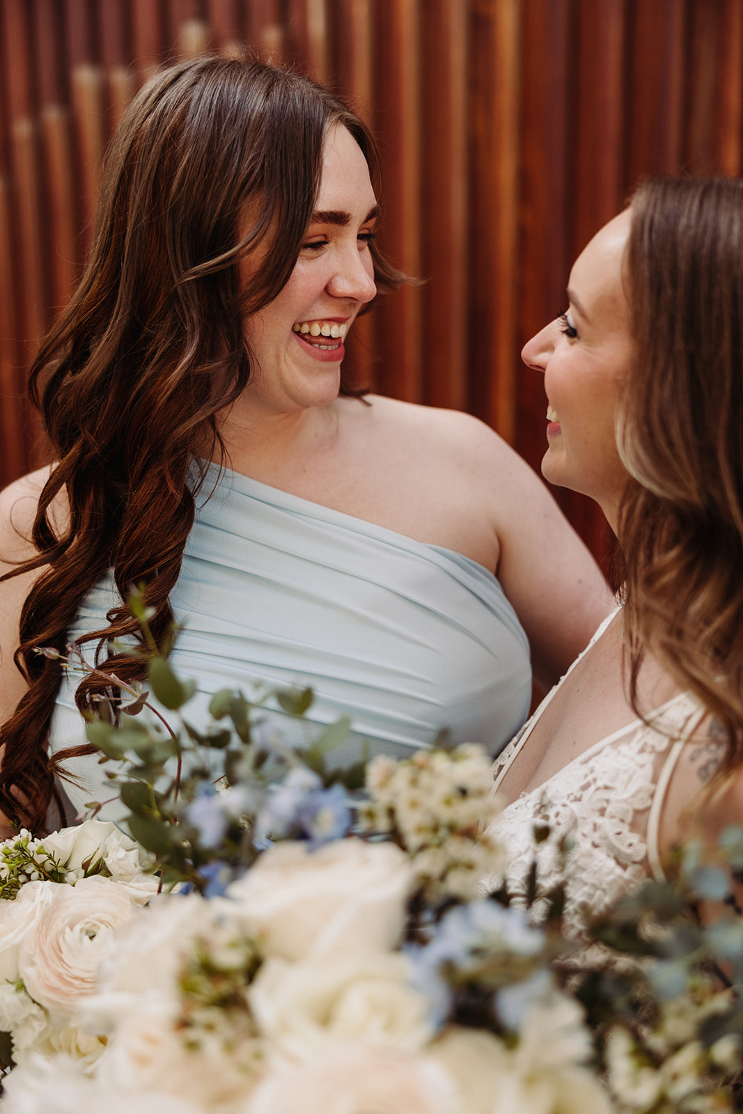 Bride smiling at bridesmaid