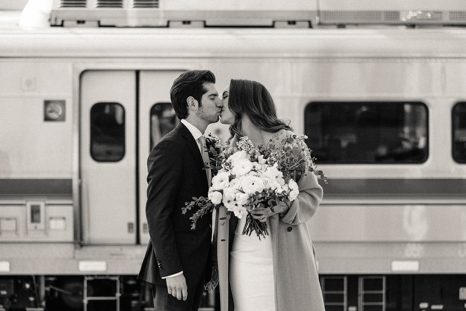 Bride and groom kissing in union station