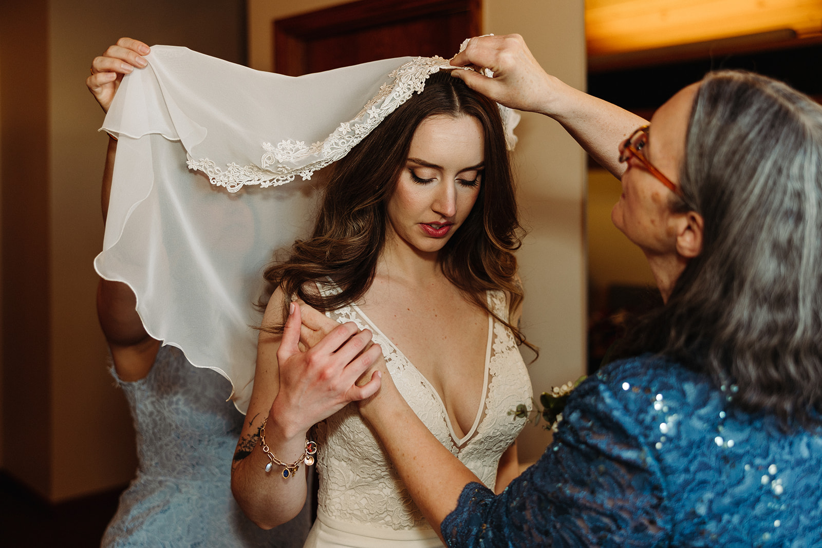 Mother putting a veil on the bride
