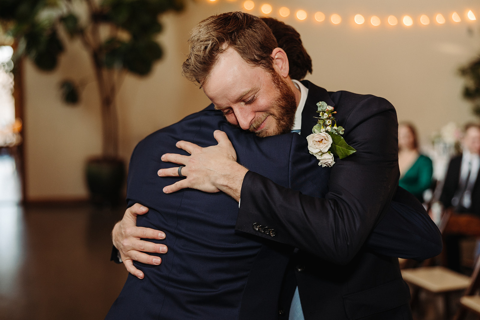 Groom hugging groomsman