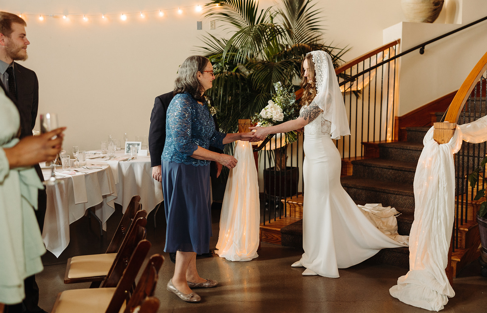 Bride taking mother's hand