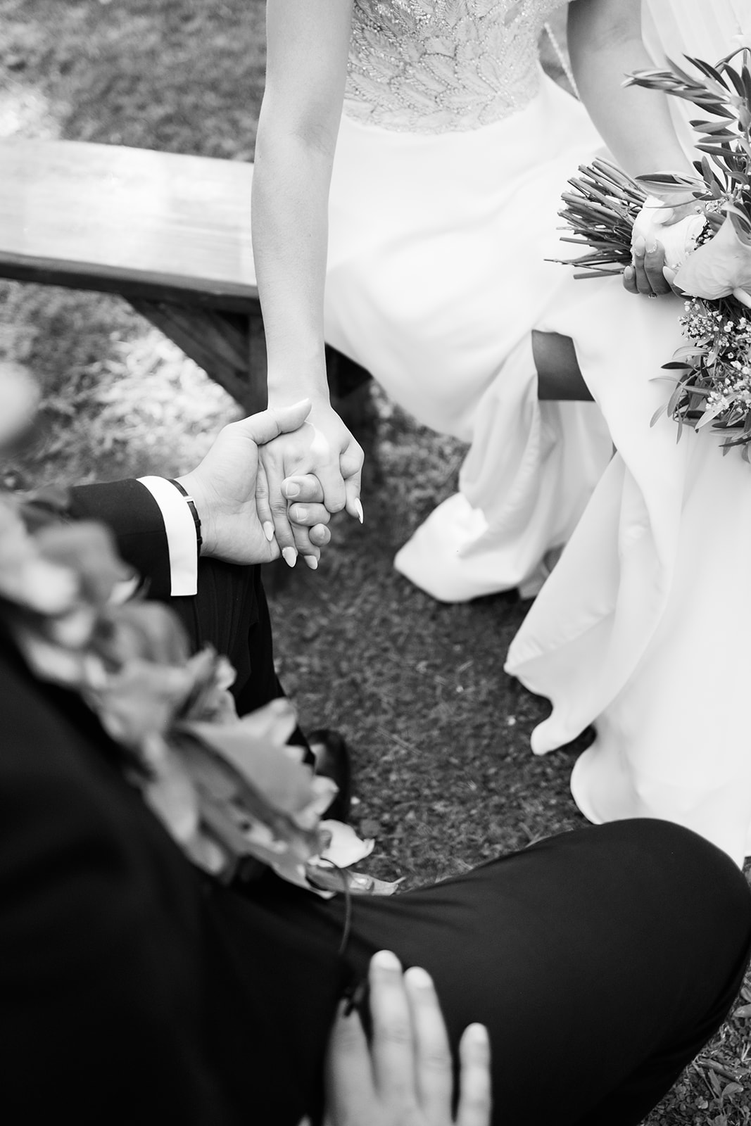 black and white photo of the bride and groom holding hands Wedding at Na Aina Kai captured by Oahu Wedding Photographer
