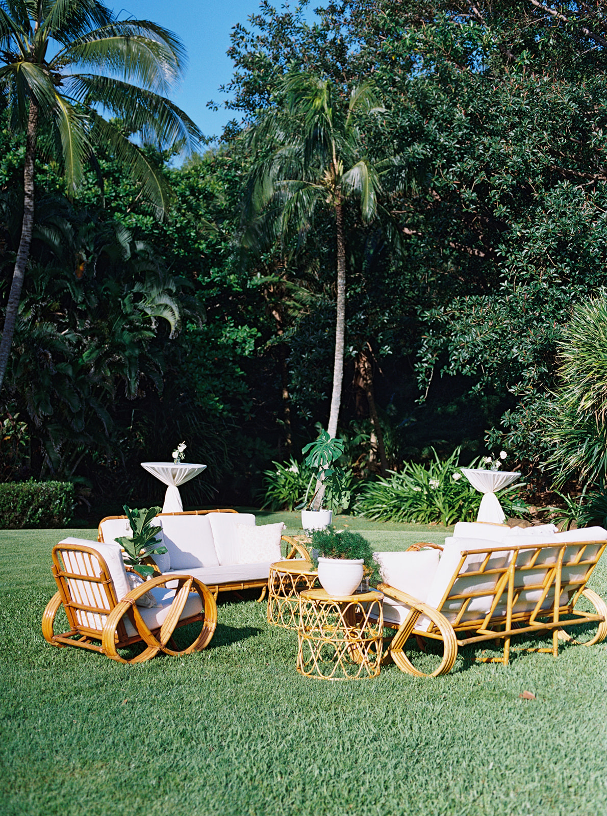 Chic outdoor seating area with rattan furniture on a well-manicured lawn Destination Wedding in Kauai
