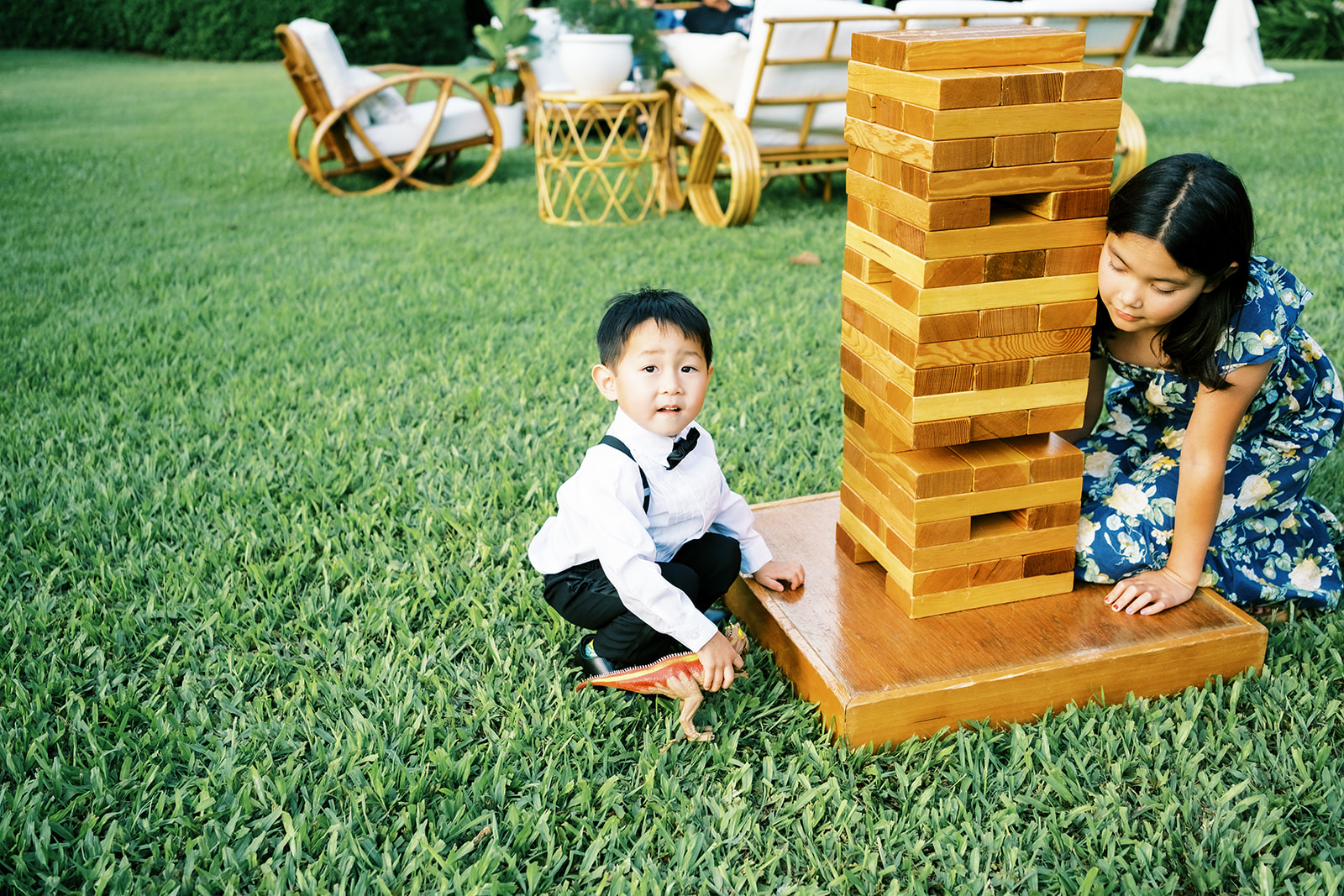 Children playing a giant block-stacking game at an outdoor event Wedding at Na ‘Āina Kai Botanical Gardens