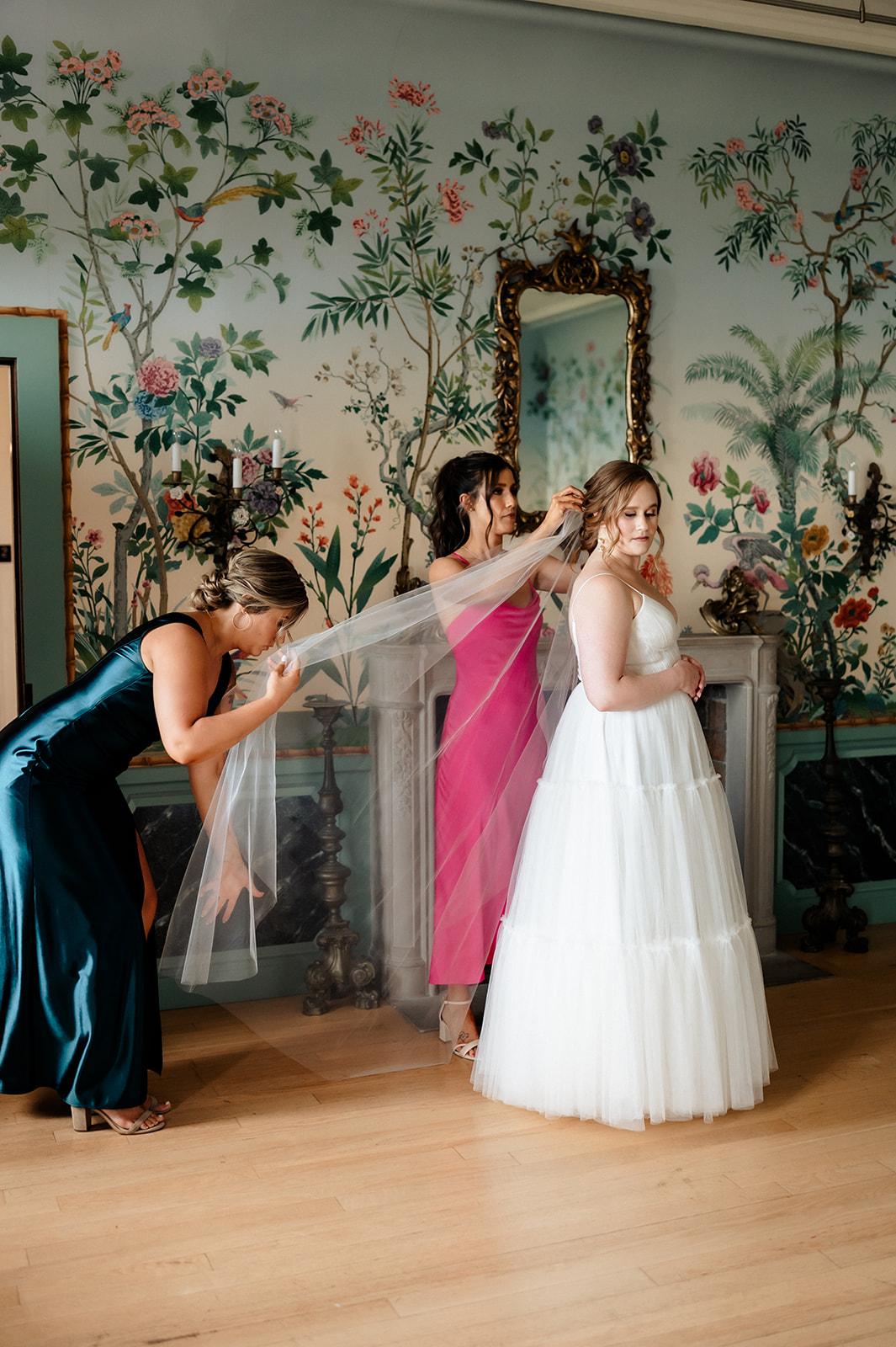 Bridesmaids finishing getting bride dressed at the Villa Terrace Decorative Art Museum. 