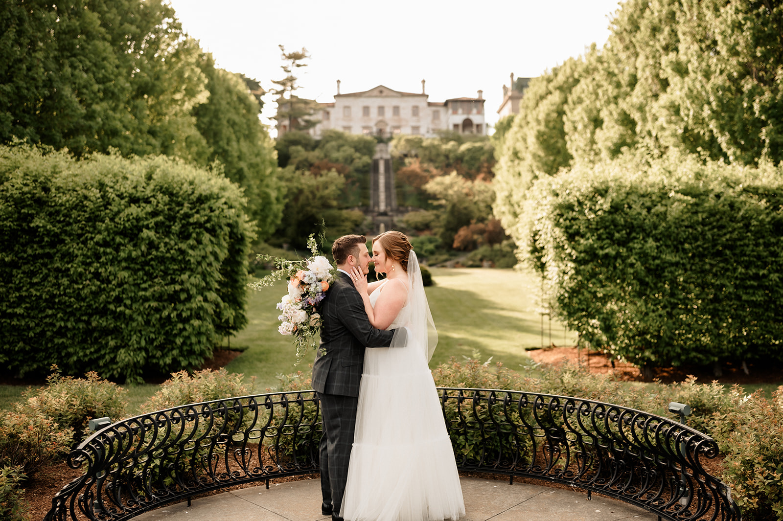 Couple who got married at Villa Terrace Decorative Art museum take portraits in beautiful gardens. 