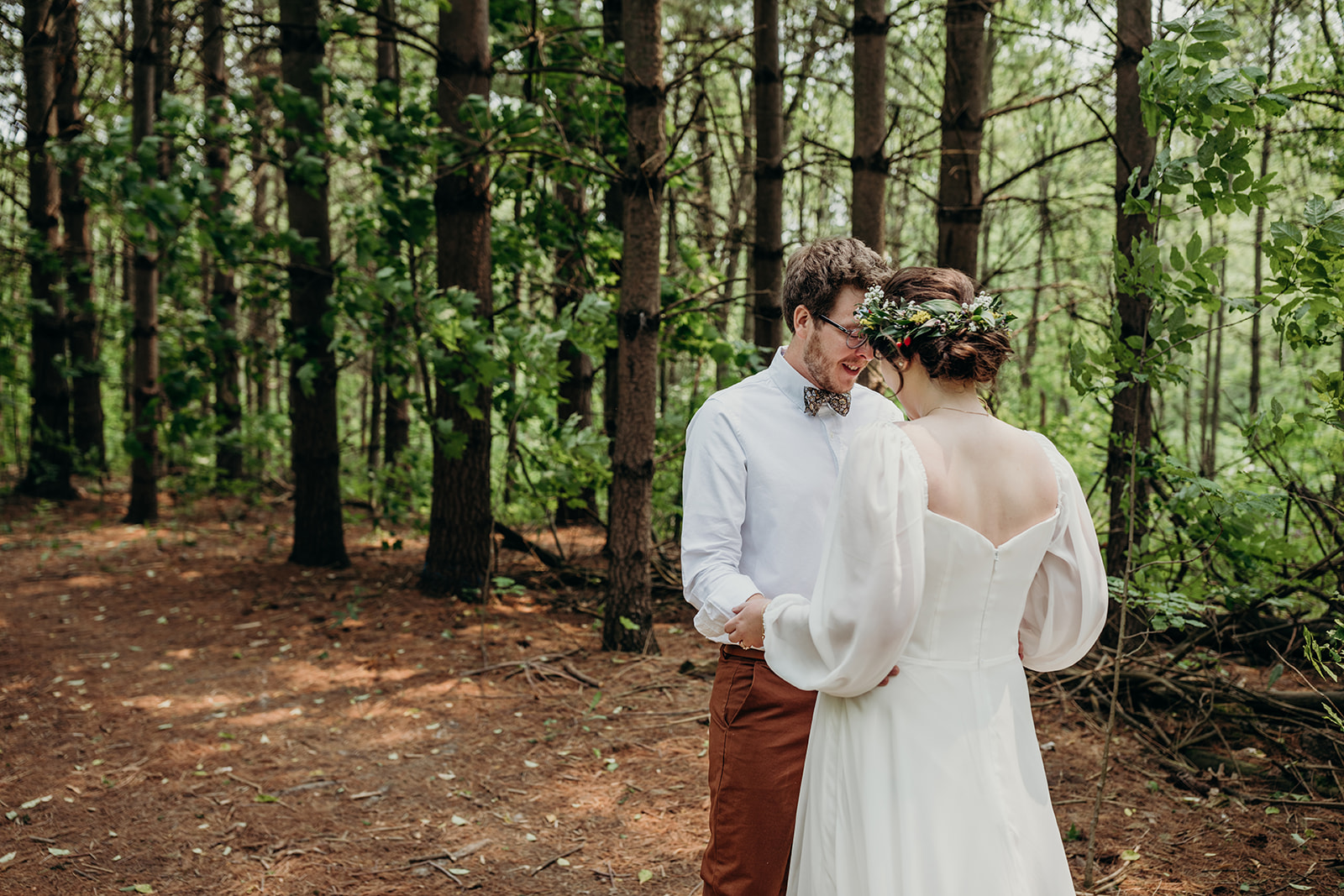 First look in the forest between bride and groom